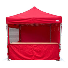 Load image into Gallery viewer, Wooden shelter table inside a gazebo pop up marquee with a half wall
