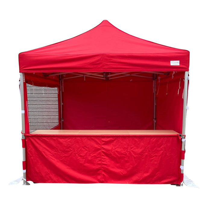 Wooden shelter table inside a gazebo pop up marquee with a half wall